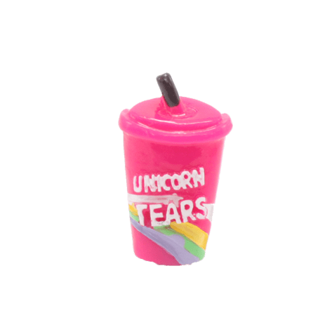 A bright pink tumbler with a straw and the words unicorn tears
