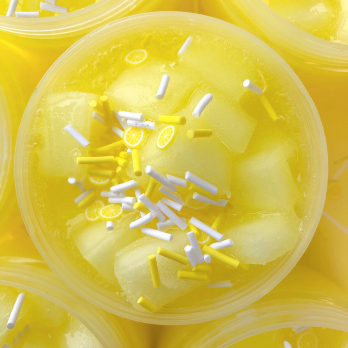 Lemonade slime with jelly cubes and yellow and white sprinkles.