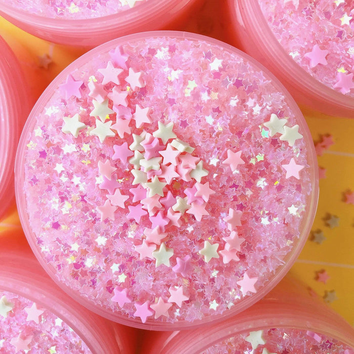 Pastel pink snow fizz slime with glitters and pastel stars in turquoise and pink colours.