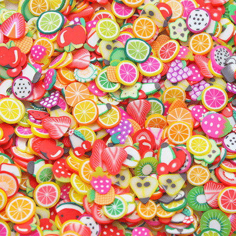 A mix of multicoloured sprinkles with several fruit shapes