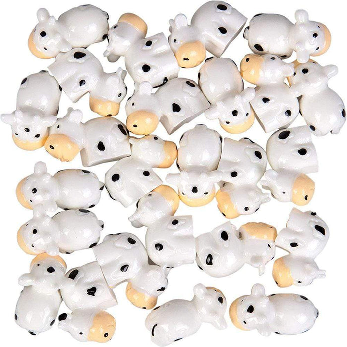 Several white cow charms