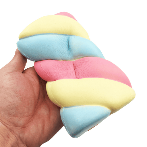 A hand holding a rectangular squishy with blue, pink and pale yellow swirls that make it look like a marshmallow
