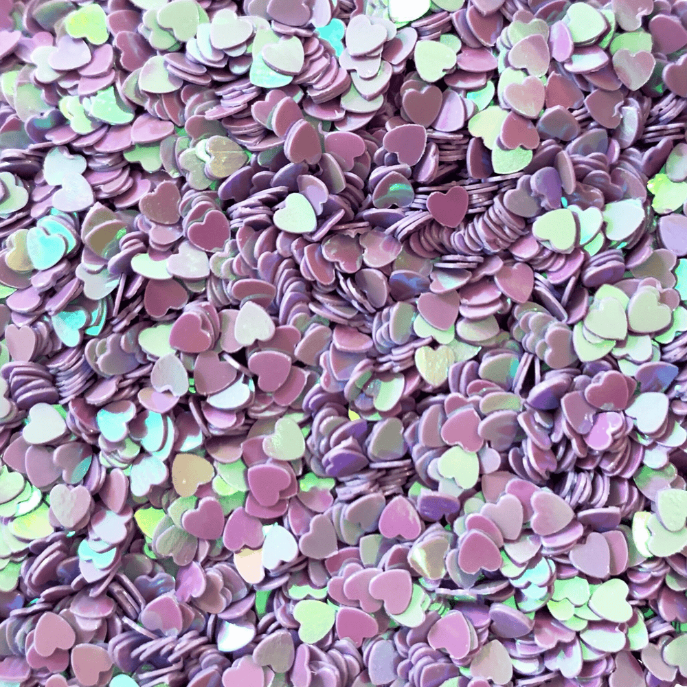 A mix of iridescent purple heart sprinkles