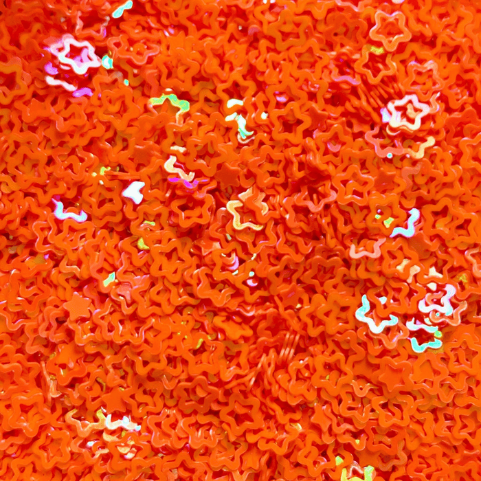 A mix or iridescent orange star sprinkles