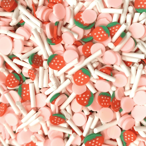 A mix of pink round sprinkles with white long sprinkles and strawberry slices 