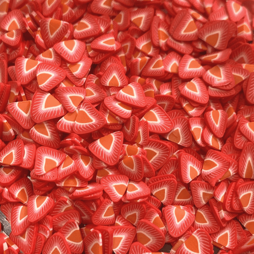 A mix of bright red strawberry shaped sprinkles