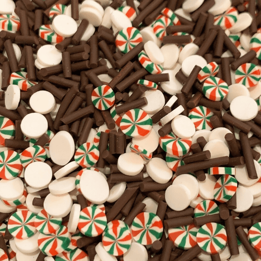 A mix of white round sprinkles, brown stick sprinkles and peppermint sprinkles