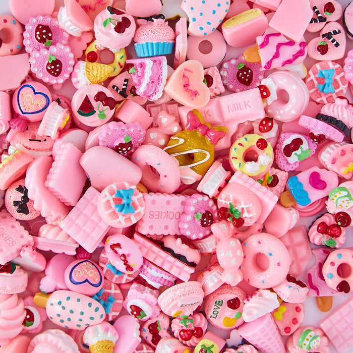 A mix of multi-shaped pink charms