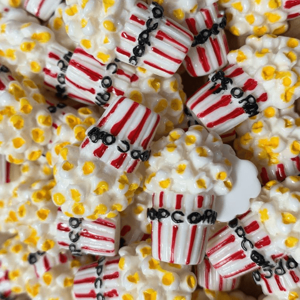 Several white and red pop corn boxes with white and yellow popcorn